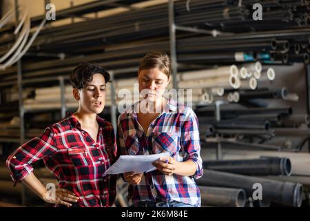 Women working in warehouse, checking documents Stock Photo