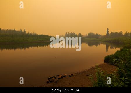 Smoke from nearby forest fires colors the daytime sky orange; Fairbanks; Alaska; USA Stock Photo