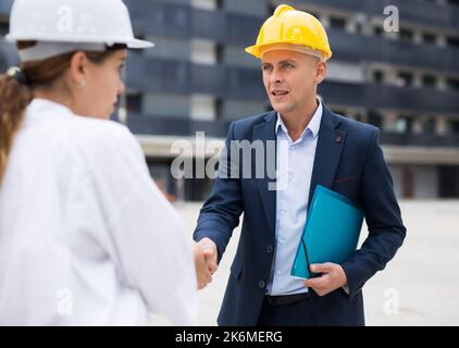Portrait of two successful architects, friendly shaking hands Stock Photo