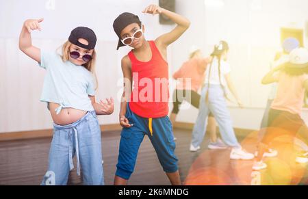 Preteen african boy and european girl hip hop dancers during group class Stock Photo