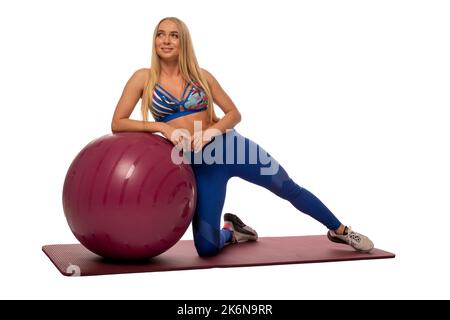 Fit woman doing exercises on fitness ball Stock Photo