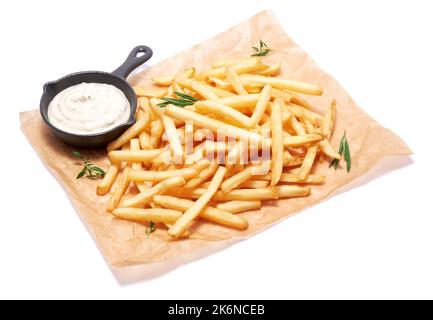 French fries potatoes on parchment paper isolated on white background Stock Photo