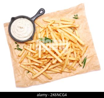 French fries potatoes on parchment paper isolated on white background Stock Photo