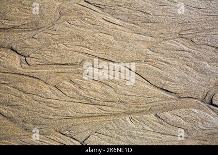 Patterns on the sand from sea water after low tide, Spain Stock Photo