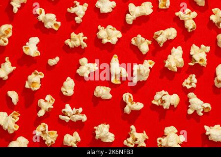 Snack concept, Arrangement of sweet popcorn isolated on red background. Stock Photo