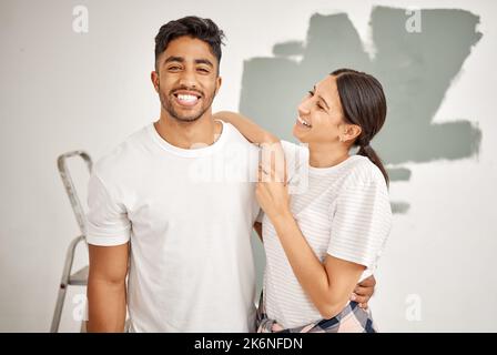 Were excited about renovating this place. a young couple painting a room together. Stock Photo