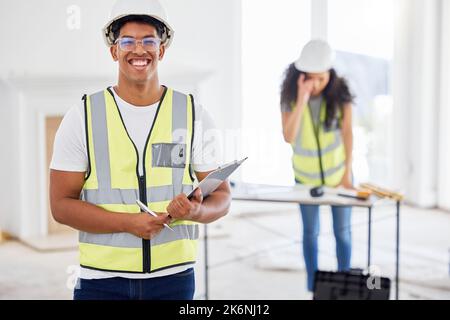 Were all set here. a handsome young contractor standing inside and using a clipboard. Stock Photo