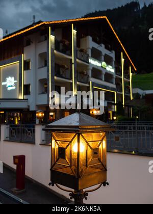 Ischgl, Austria - July 25, 2022: Night scenery of a street lantern and a hotel in Ischgl in background Stock Photo