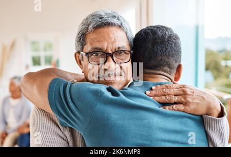 Hes never too old for a hug. a father and son hugging at home. Stock Photo