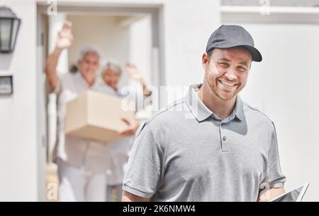 Another satisfied customer. Cropped portrait of a handsome young male courier leaving his customers home after making a delivery. Stock Photo