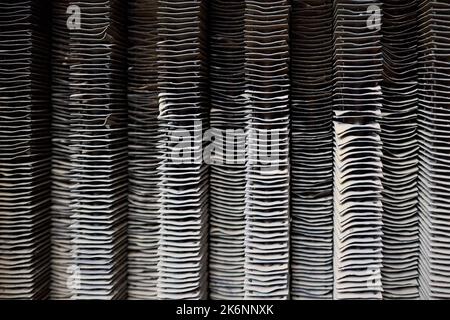Plate-fin heat exchanger surface closeup texture. Old heat exchange equipment bent plates with traces of corrosion rust. Selective focus industrial Stock Photo