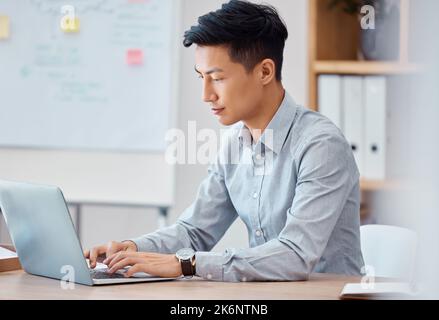 Programmer, laptop and software engineer working, coding and typing up cyber security data on the internet. Digital, web design and young Asian Stock Photo