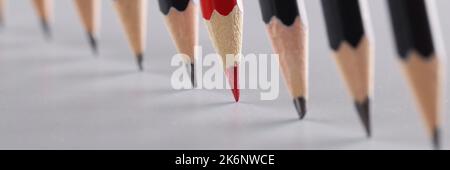 Sharp pencils in a row on a gray background Stock Photo