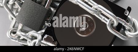 The hard drive is wrapped with a chain with a padlock Stock Photo