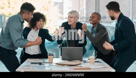We did it. a diverse group of businesspeople celebrating a success during a meeting in the office. Stock Photo