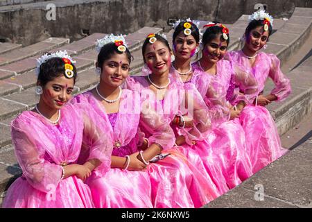 Women wear traditional dresses with floral ornaments and perform during Spring Festival, the first day of Spring of the Bengali month ''Falgun''. Stock Photo