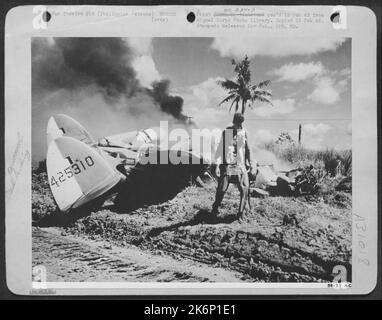 MIRACULOUS ESCAPE--A dramatic picture of Lt. S.F. Ford, fighter-pilot from Baltimore, Maryland, walking from his Lockheed P-38 Lightning unharmed a few seconds after he crash landed. He was shot down in flames by a Jap Zero over Mindoro Island Stock Photo