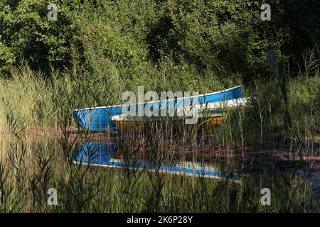 Two rowing boats on a sandy beach among the reeds in Repovesi National Park, Finland Stock Photo