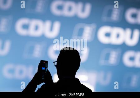 Villingen Schwenningen, Germany. 15th Oct, 2022. A man stands in front of the stage with a smartphone before the start of the Baden-Württemberg CDU state party conference at the exhibition center. Credit: Silas Stein/dpa/Alamy Live News Stock Photo