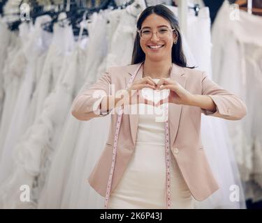 Ive never met someone so passionate about wedding couture. an attractive young seamstress working in a bridal boutique. Stock Photo
