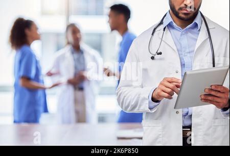 Whos my next patient. an unrecognizable doctor using a digital tablet at work. Stock Photo