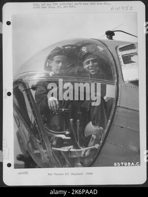 Two Members Of Crew 12 Of The 615Th Bomb Squadron, 401St Bomb Group, In The Nose Of A Boeing B-17 Flying Fortress. England, 25 March 1945. Stock Photo