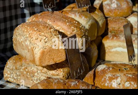 Crusty Seeded Artisan Bread For Sale On A Market Stall, Christchurch Market UK Stock Photo