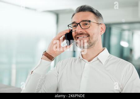 Do we have a deal. a mature businessman sitting alone in his office and using his cellphone. Stock Photo