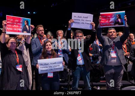 Berlin, Germany. 15th Oct, 2022. Guests from the Komala Party of Iranian Kurdistan hold up placards to protest the government in Iran during the Congress of the Party of European Socialists (PES). Credit: Carsten Koall/dpa/Alamy Live News Stock Photo