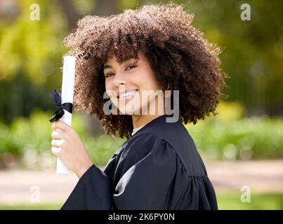All my hard work led to this joyful occasion. Portrait of a young woman holding her diploma on graduation day. Stock Photo