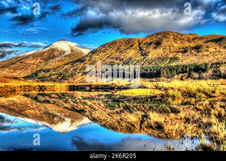 Area of Crianlarich, Scotland. Artistic dusk view of the River Fillan with a snow capped Ben More in the background. Stock Photo