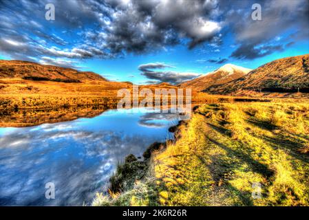 Area of Crianlarich, Scotland. Artistic dusk view of the River Fillan with a snow capped Ben More in the background. Stock Photo