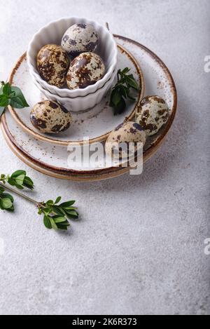 Bowl with quail eggs on light background Stock Photo