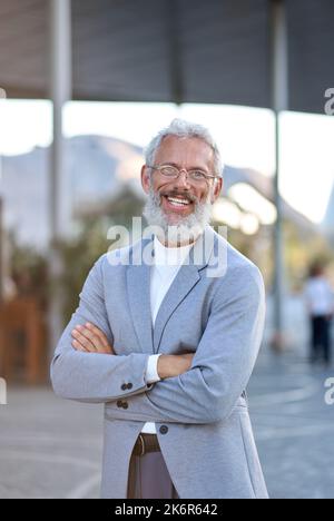Confident happy mature older business man outdoors, vertical portrait. Stock Photo