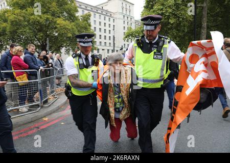 London, UK. 14th Oct, 2022. 14th October 2022, London, UK. Arrests as Just Stop Oil protestors block road outside of New Scotland Yard in London. Credit: Isles Images/Alamy Live News Stock Photo