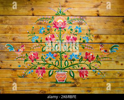 Ukrainian Petrykivka tray, traditional decorative painting style, handicraft souvenirs on dark wooden background Stock Photo