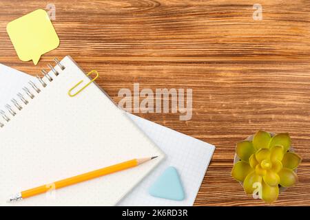 Notepad with school supplies on a wooden desk. Stock Photo