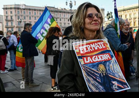 A woman holds a placard reading 'Stop the war' during a demo organised by Unione Popolare in Milan, Italy on October 15, 2022 Credit: Piero Cruciatti/Alamy Live News Stock Photo