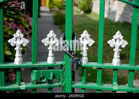 Padlocked green gate Stock Photo