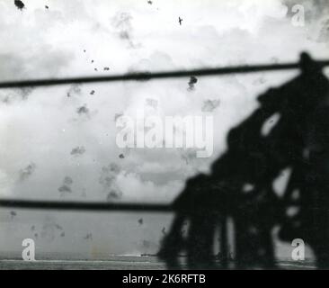 Photograph Taken By the USS Enterprise During the Battle of Santa Cruz'Attacking Japanese planes in the Battle of Santa Cruz…Japanese bomber hit by anti-aircraft fire from the USS Enterprise [CV-6] and the USS South Dakota. The stern of the South Dakota (BB-57) is visible in the wake. Photograph taken by the Enterprise.'. Stock Photo