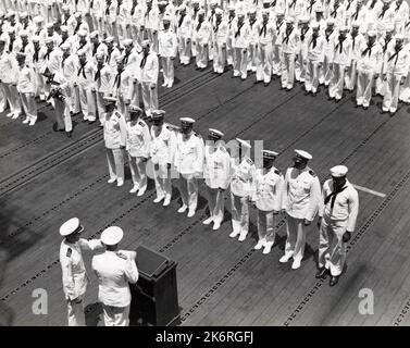 Naval Officers and Enlisted Men Await Presentation of Individual Heroism'Naval officers and enlisted men await presentation of individual heroism awards by Adm. Chest W. Nimitz at Pearl Harbor. The ceremony was held on the flight deck of the USS Enterprise (CV-6).' Photographer: USS Enterprise. Stock Photo