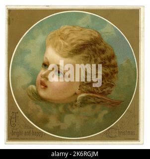 Original charming Victorian Christmas card of a winged cherub, with gilt border. The message is 'A bright and happy Christmas' Circa early 1890's. Stock Photo