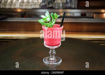 Popular summer fruit coctail on bar interior buckground close-up. Stock Photo