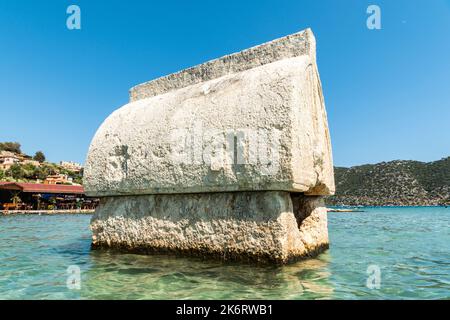 Semi-submerged Lycian sarcophagus tomb by the shore of Kalekoy village of the Demre district in the Antalya Province of Turkey. Stock Photo