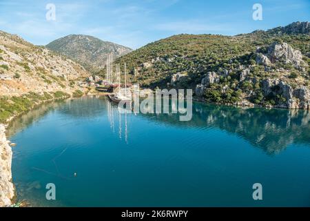 Harbour with a small shipyard along the Mediterranean coastline in Bozburun village near Marmaris resort town in Mugla province of Turkey. View with g Stock Photo