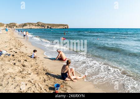 Patara, Antalya, Turkey – August 12, 2021. Patara beach in Antalya province of Turkey, with people. The splendid 18-km long sandy beach is backed by l Stock Photo