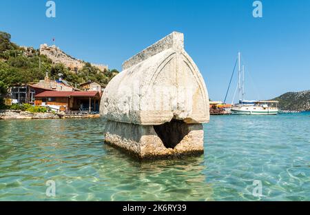 Kalekoy, Antalya, Turkey – August 14, 2021. Semi-submerged Lycian sarcophagus tomb by the shore of Kalekoy village of the Demre district in the Antaly Stock Photo