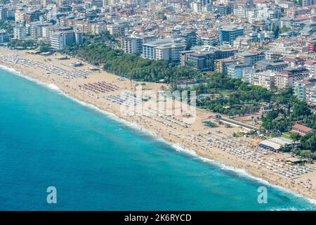 Alanya, Turkey – August 18, 2021. Aerial view over Cleopatra’s Beach in Alanya, Turkey. View with residential buildings behind the beach. Stock Photo