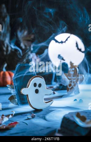 Spooky Halloween background. Cemetery and gravestones at scary night and at blue moonlight. Flying cute spooky monster ghost. Bat silhouettes. Cemeter Stock Photo