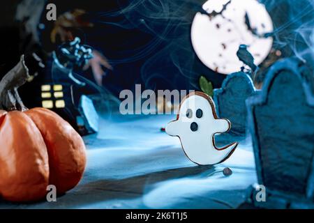 Scary Halloween background. Night scary cemetery with gravestones under the blue light of the moon. Flying cute spooky ghost. Bat silhouettes. Cemeter Stock Photo